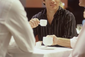 Men Sitting at Table Drinking Espresso